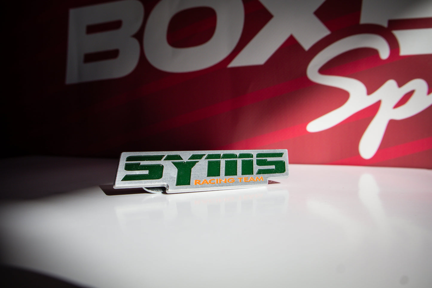 SYMS RACING TEAM FRONT GRILLE EMBLEM